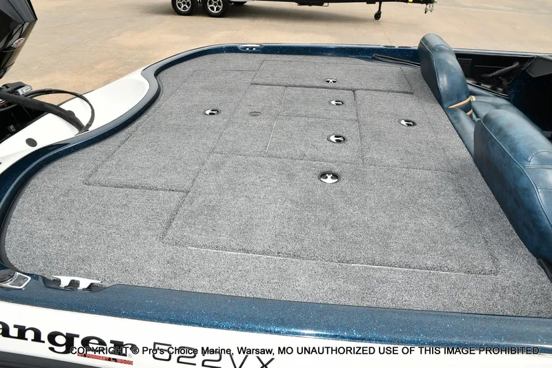 Slide: The Image of Ranger 522vx boat with gray carpeted deck and blue seats, 2002 model. - 46