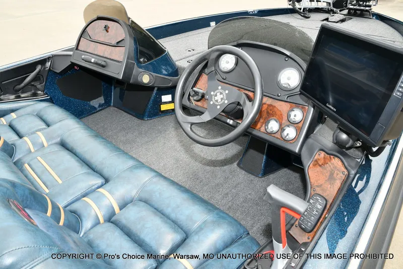 Slide: The Image of Interior of a 2002 Ranger 522vx boat with steering console. - 47
