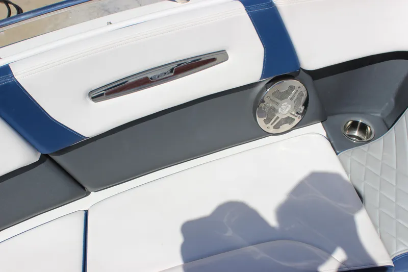 Slide: The Image of 2020 Chaparral 277 SSX boat interior with blue and white seating, speaker, and cup holder. - 11