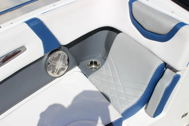 Slide: The Image of 2020 Chaparral 277 SSX boat interior with blue and gray seating, speaker, and cup holder. - 12