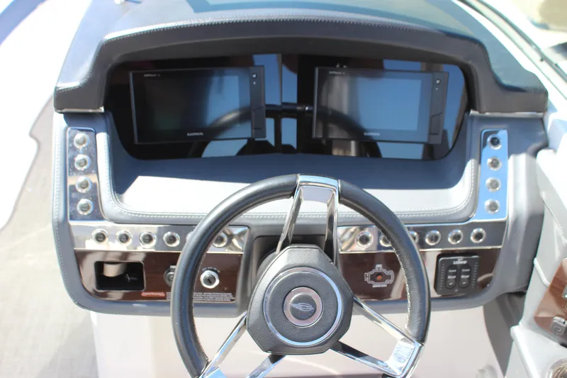 Slide: The Image of 2020 Chaparral 277 SSX dashboard with dual Garmin displays and sleek steering wheel. - 15