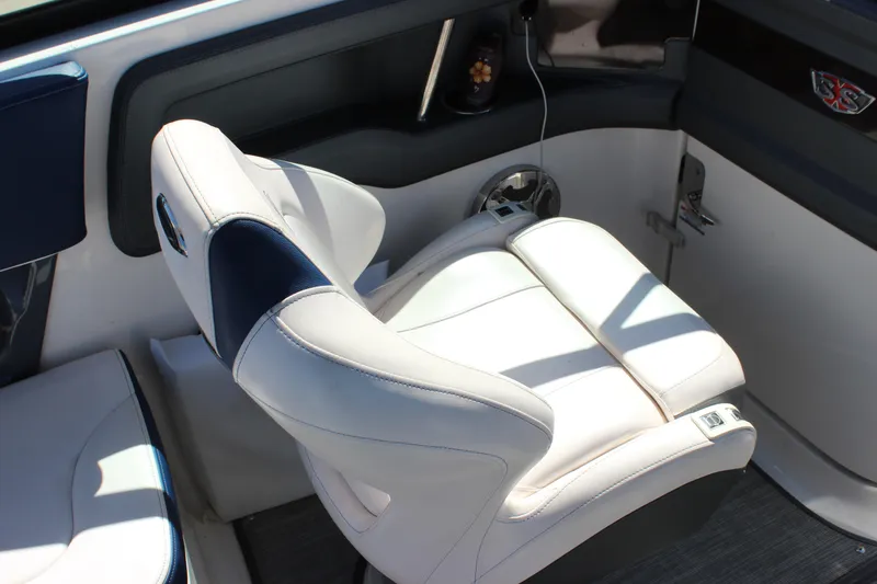 Slide: The Image of 2020 Chaparral 277 SSX boat interior with luxurious white and navy seating. - 17
