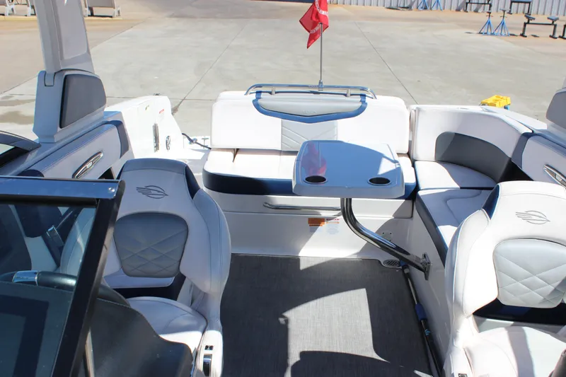 Slide: The Image of 2020 Chaparral 277 SSX boat interior with luxurious seating and table setup. - 18