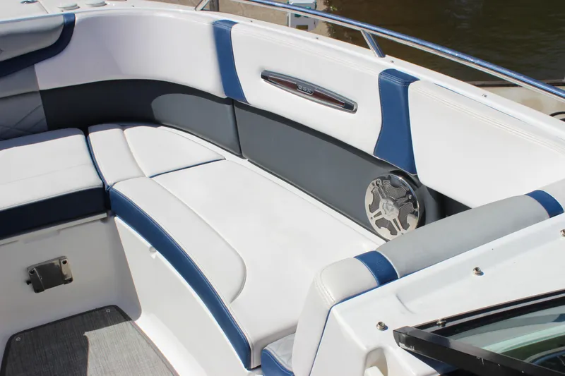 Slide: The Image of 2020 Chaparral 277 SSX boat interior with white and blue seating, featuring a speaker. - 26