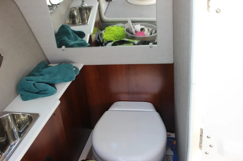 Slide: The Image of 2020 Chaparral 277 SSX boat bathroom with sink, mirror, and toilet. - 28
