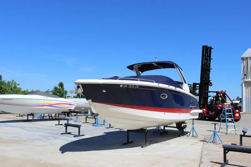 Slide: The Image of 2020 Chaparral 277 SSX boat on stands in a sunny marina setting. - 3