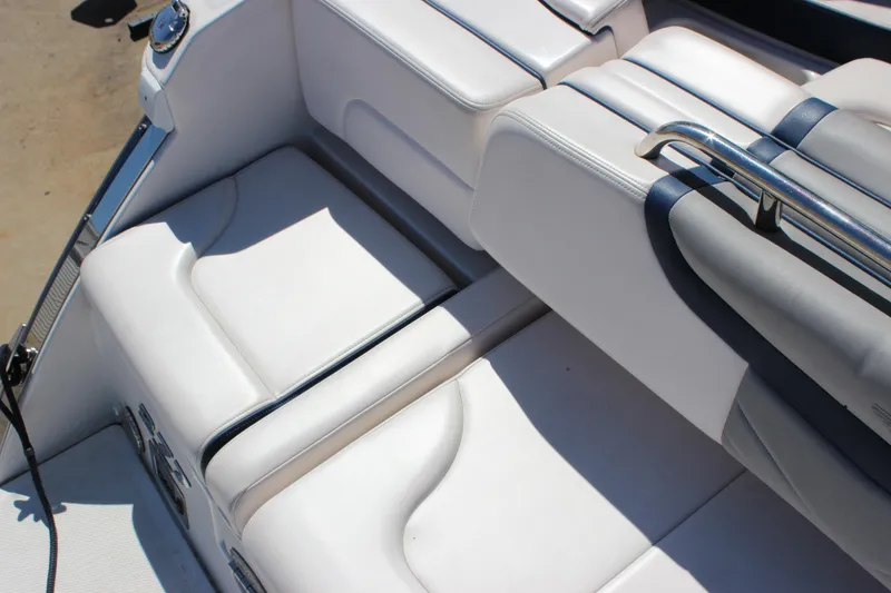 Slide: The Image of 2020 Chaparral 277 SSX boat interior seating with white upholstery and stainless steel accents. - 30