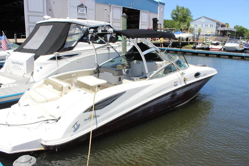 The Image of 2007 Sea Ray 270 Sundeck boat docked at marina, featuring sleek design and spacious seating. - 0