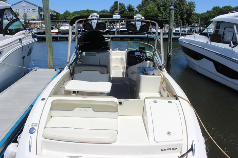 Slide: The Image of 2007 Sea Ray 270 Sundeck boat docked at marina, featuring spacious seating and helm. - 11