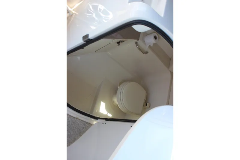 Slide: The Image of 2007 Sea Ray 270 Sundeck boat interior with compact marine toilet. - 23