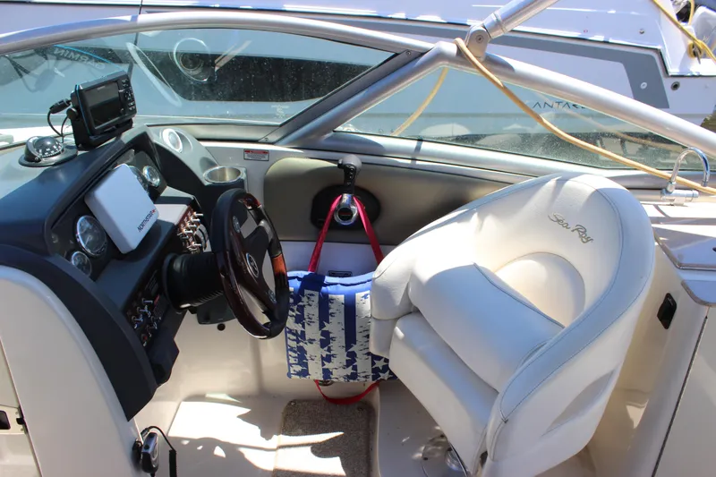 Slide: The Image of Interior of a 2007 Sea Ray 270 Sundeck boat with steering wheel and dashboard. - 7