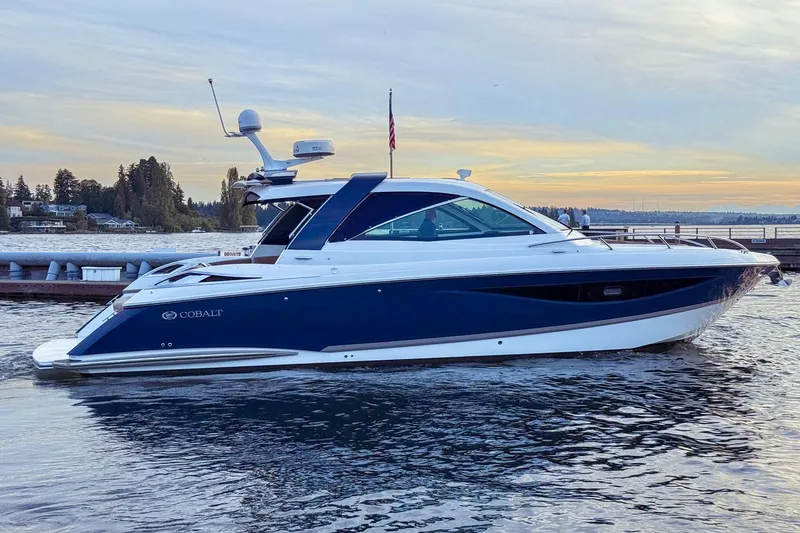 Slide: The Image of 2017 Cobalt A40 Coupe luxury boat docked on serene water at sunset. - 12