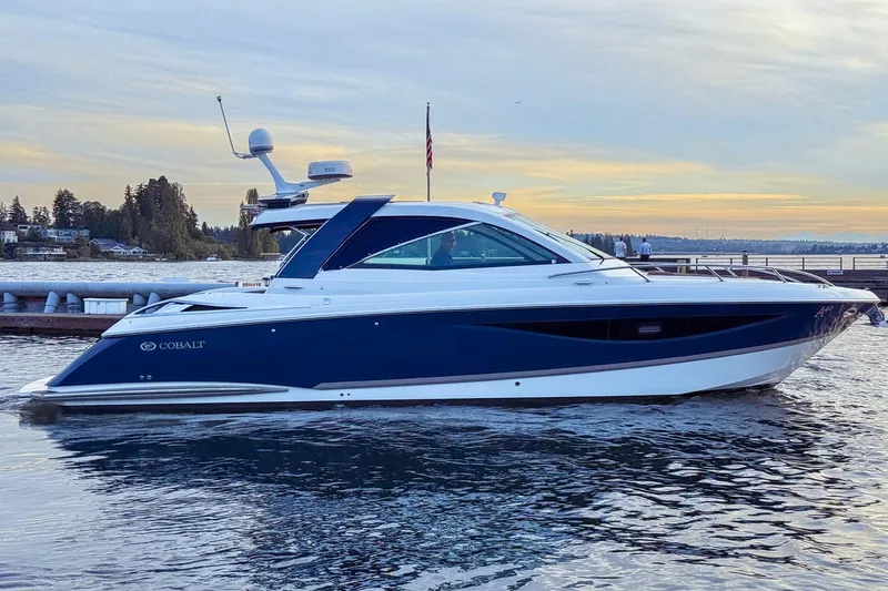 Slide: The Image of 2017 Cobalt A40 Coupe luxury boat docked on serene water at sunset. - 13