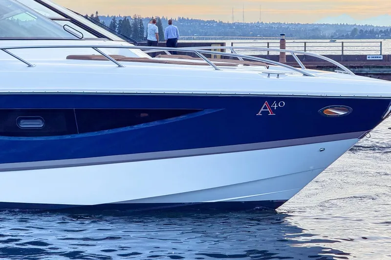 Slide: The Image of 2017 Cobalt A40 Coupe yacht docked by a scenic waterfront. - 16