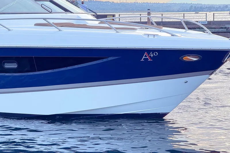Slide: The Image of 2017 Cobalt A40 Coupe boat docked on calm water. - 17