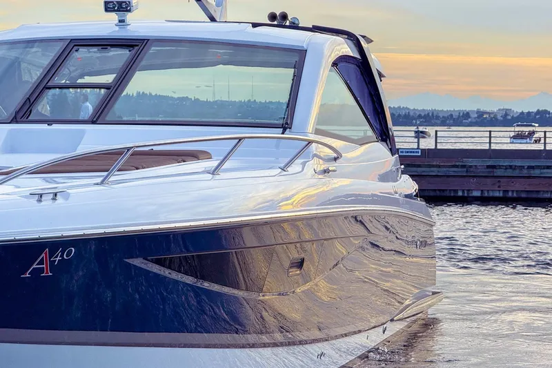 Slide: The Image of 2017 Cobalt A40 Coupe yacht docked at sunset, reflecting serene waters and scenic background. - 21