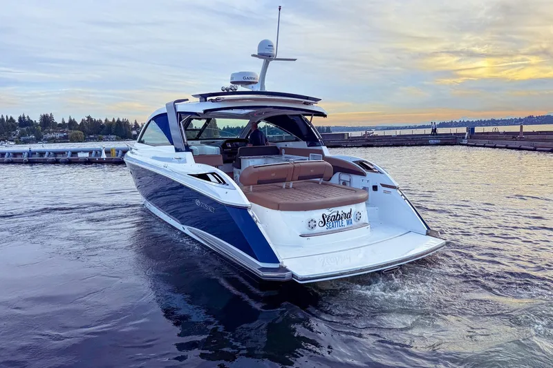 Slide: The Image of 2017 Cobalt A40 Coupe yacht cruising on a serene lake at sunset. - 3