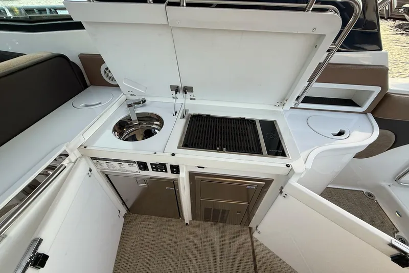 Slide: The Image of 2017 Cobalt A40 Coupe yacht kitchenette with sink, grill, and storage compartments. - 31