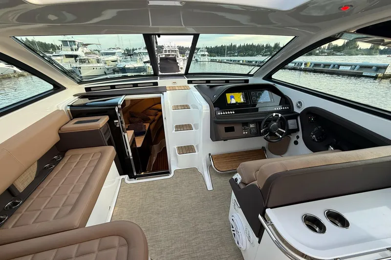 Slide: The Image of Interior of a 2017 Cobalt A40 Coupe yacht with luxurious seating and modern dashboard. - 34