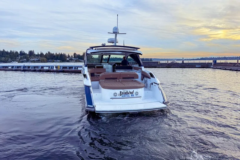 Slide: The Image of 2017 Cobalt A40 Coupe boat on water at sunset near Seattle dock. - 4