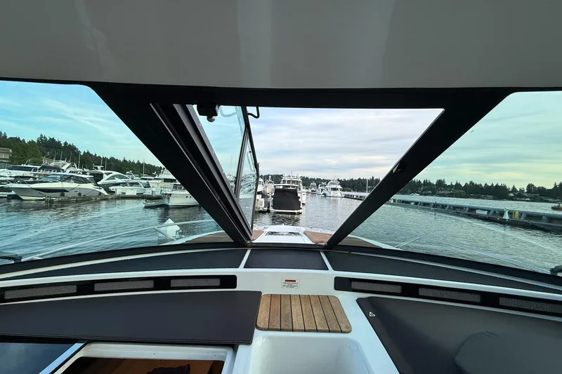 Slide: The Image of View from 2017 Cobalt A40 Coupe cockpit overlooking marina with boats and calm water. - 46
