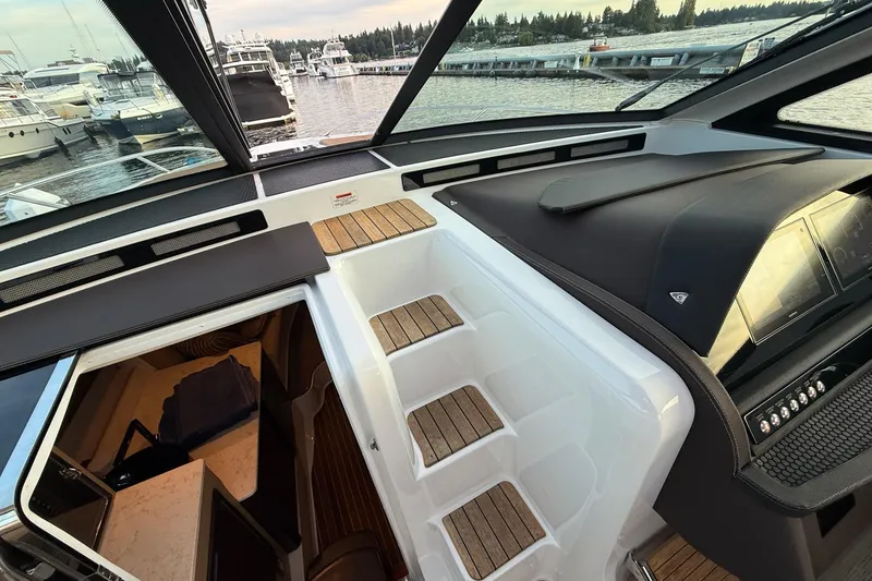 Slide: The Image of Interior view of 2017 Cobalt A40 Coupe yacht with wooden steps and dashboard. - 48