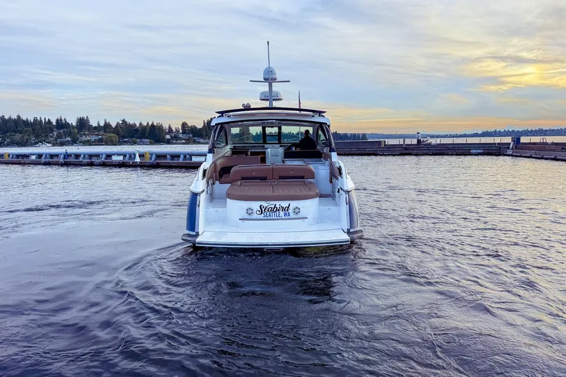 Slide: The Image of 2017 Cobalt A40 Coupe boat on water near Seattle dock at sunset. - 5