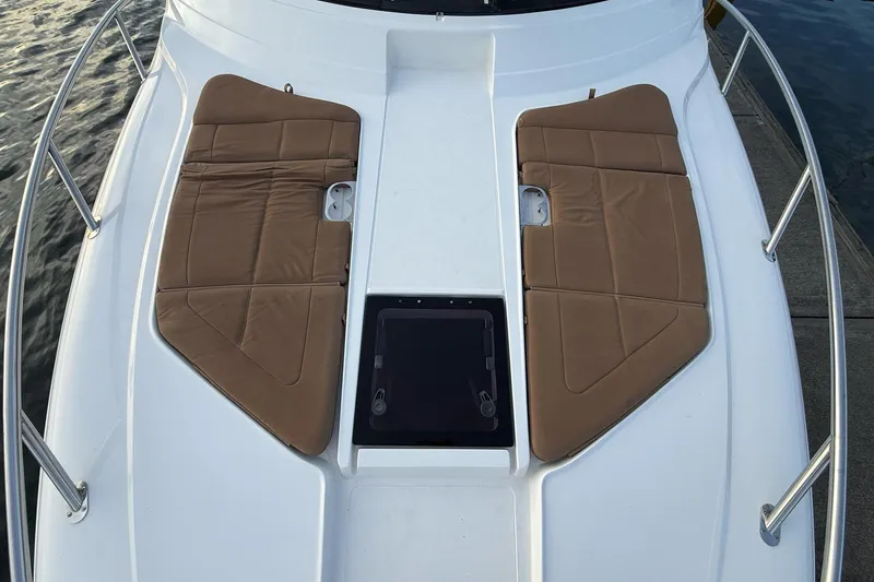 Slide: The Image of 2017 Cobalt A40 Coupe boat deck with brown cushioned seating and railing. - 51