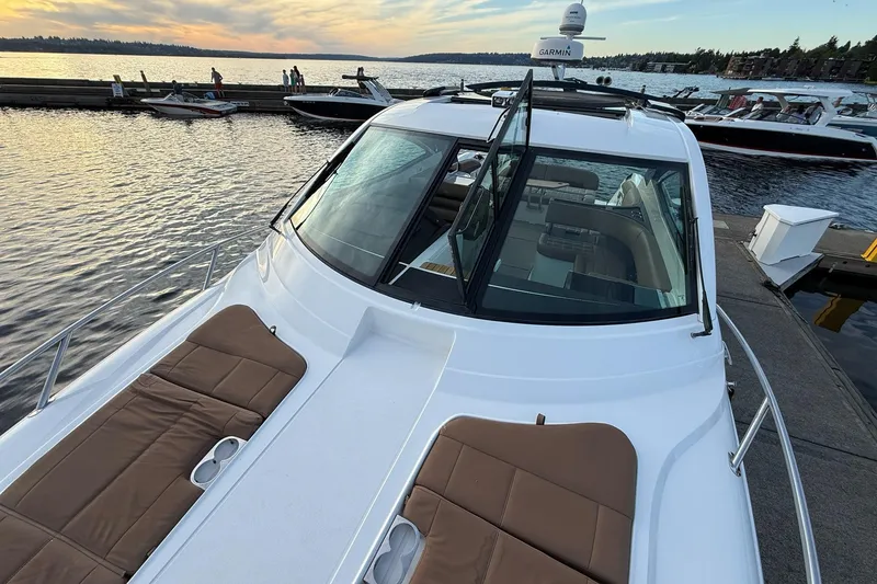 Slide: The Image of 2017 Cobalt A40 Coupe yacht docked at sunset, featuring sleek design and comfortable seating. - 52