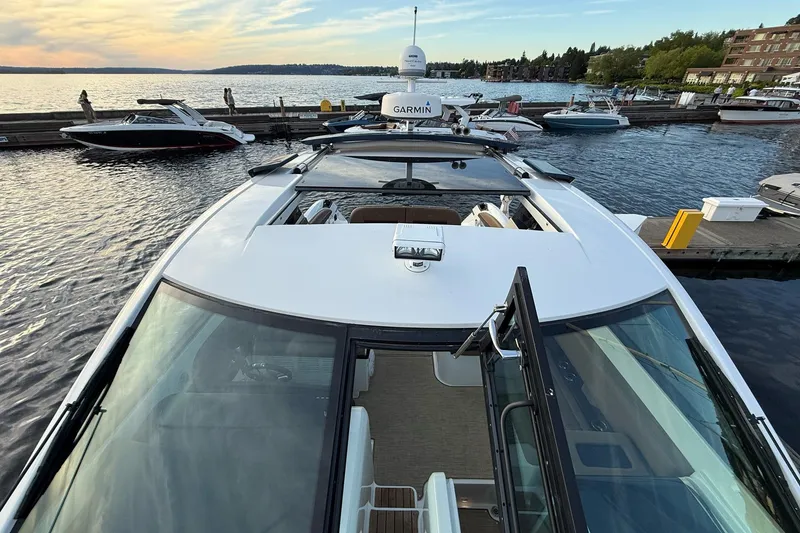 Slide: The Image of 2017 Cobalt A40 Coupe docked at a scenic marina during sunset. - 54