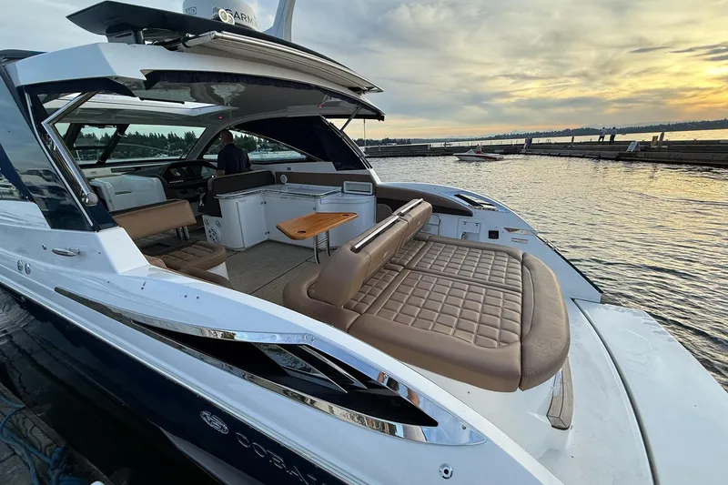 Slide: The Image of Luxurious 2017 Cobalt A40 Coupe yacht docked at sunset, featuring spacious seating and sleek design. - 56
