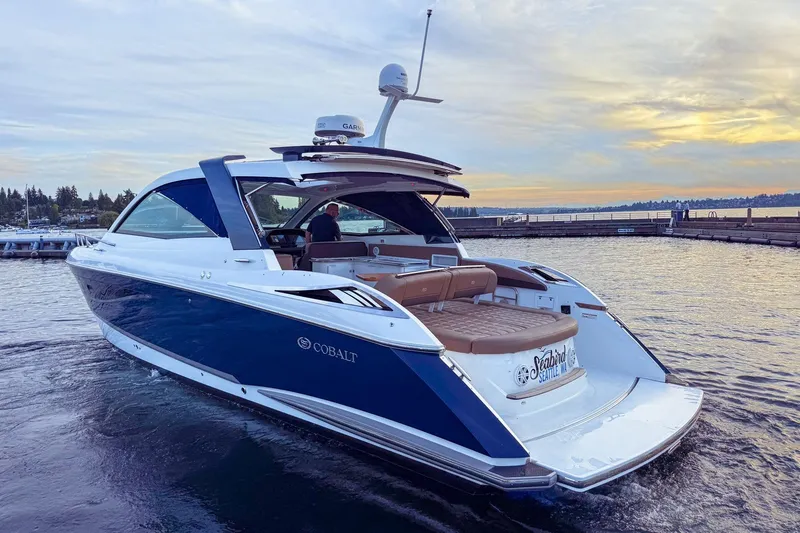Slide: The Image of 2017 Cobalt A40 Coupe yacht cruising on a serene lake at sunset. - 57