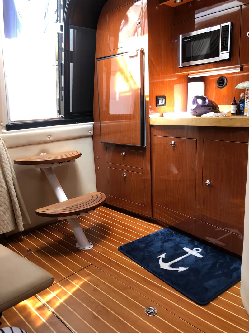 Slide: The Image of Interior of 2009 Regal Commodore 3760 IO yacht with wooden flooring and kitchenette. - 14