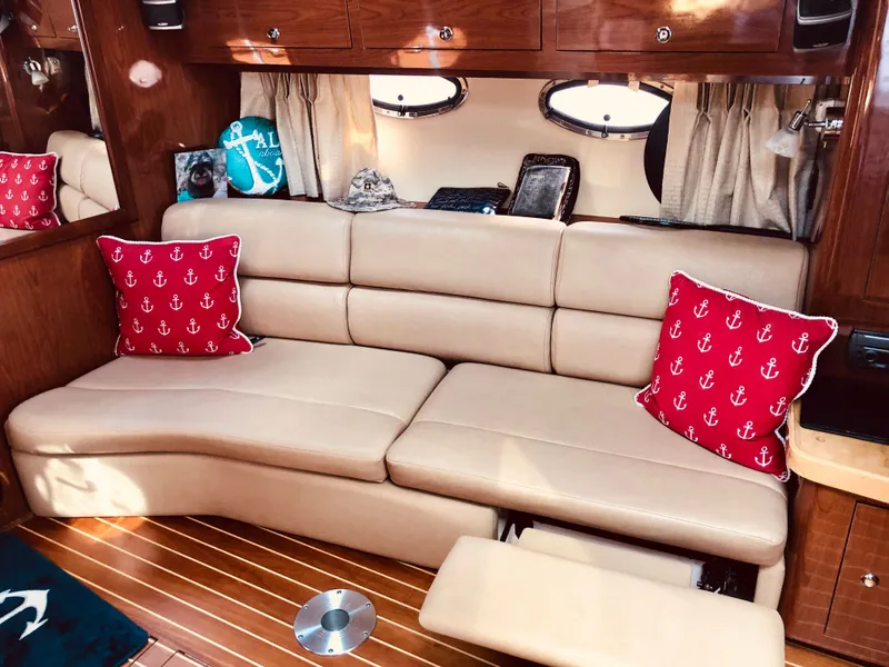 Slide: The Image of Interior of 2009 Regal Commodore 3760 IO with beige sofa and red pillows. - 18