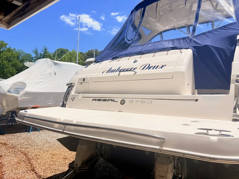 Slide: The Image of A 2009 Regal Commodore 3760 IO is on dry dock, featuring a blue cover. - 28