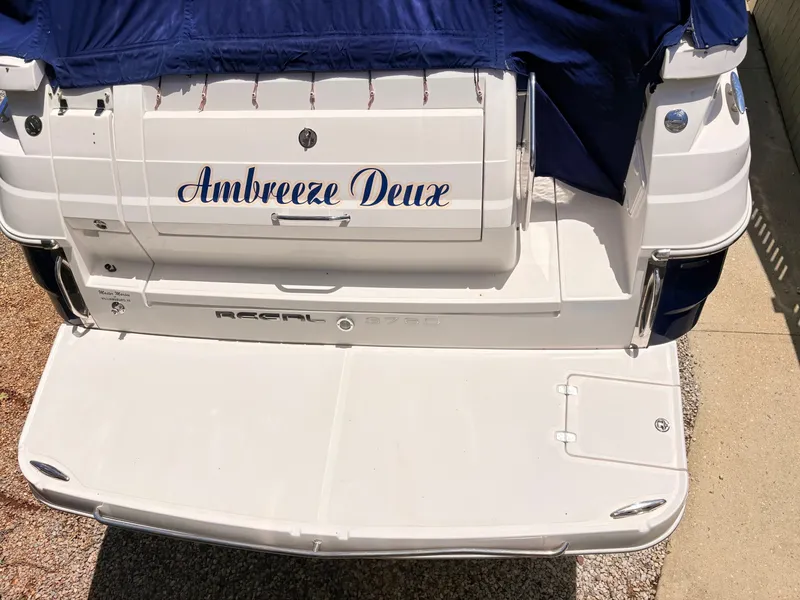 Slide: The Image of Rear view of a 2009 Regal Commodore 3760 IO with a blue cover. - 29