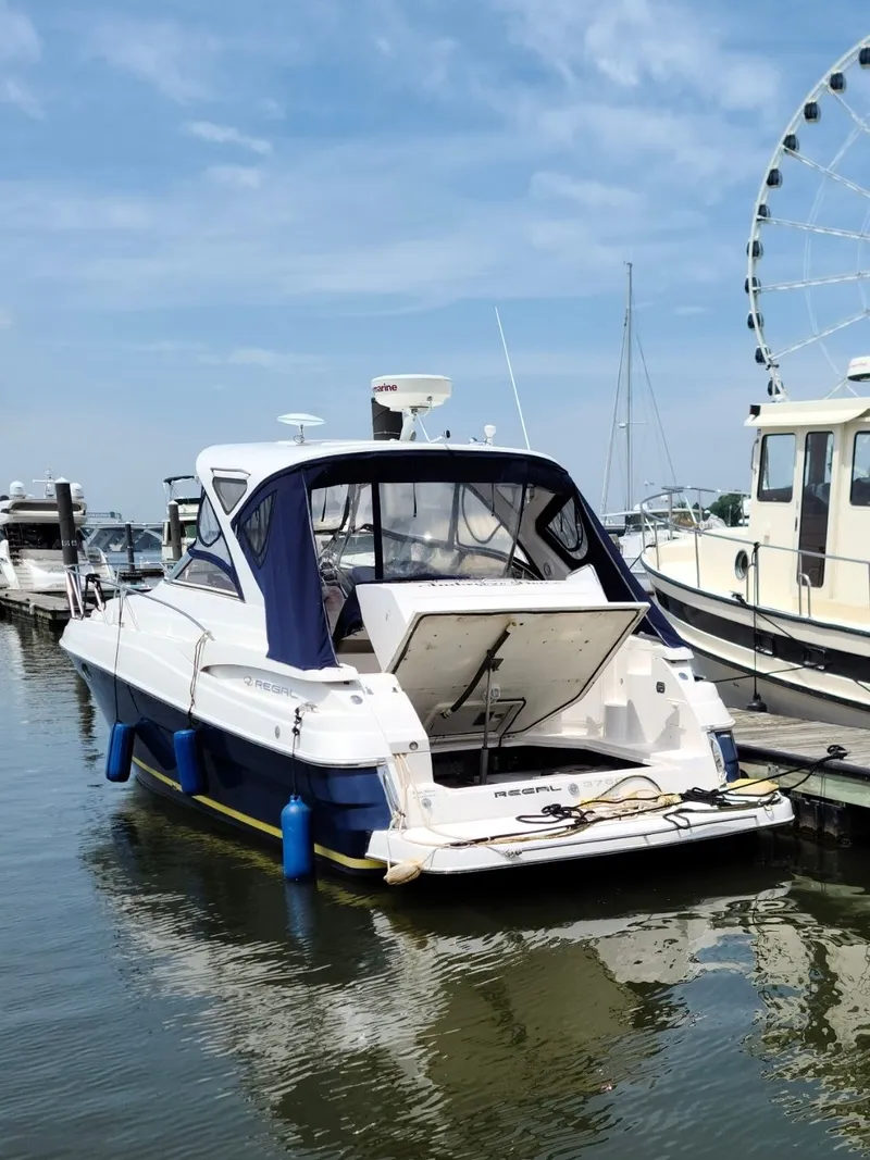 Slide: The Image of 2009 Regal Commodore 3760 IO yacht docked with ferris wheel in background. - 36