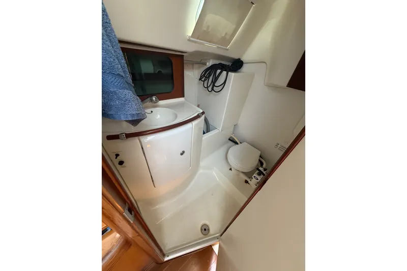 Slide: The Image of Bathroom interior of 2002 Beneteau Oceanis Clipper 311 yacht, featuring sink and toilet. - 14