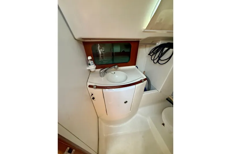 Slide: The Image of Compact bathroom in 2002 Beneteau Oceanis Clipper 311 yacht, featuring sink and storage. - 16
