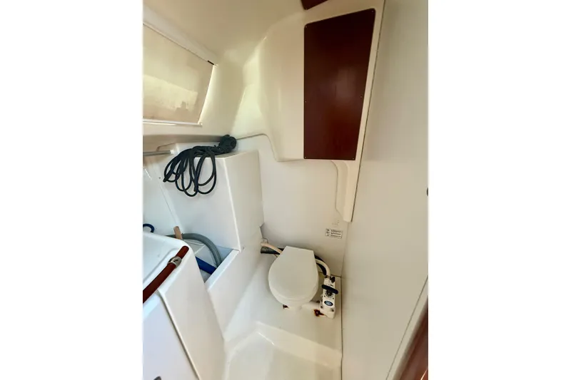 Slide: The Image of Interior of 2002 Beneteau Oceanis Clipper 311 yacht bathroom with toilet and storage. - 17