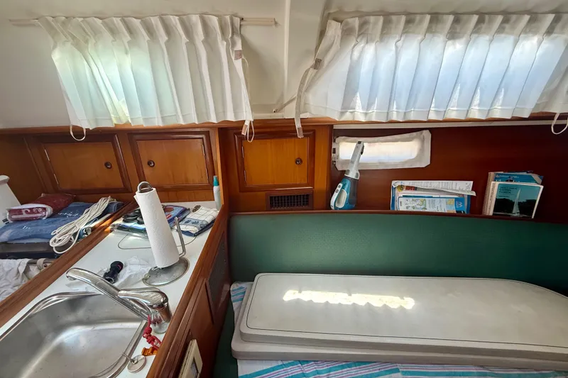 Slide: The Image of Interior of 2002 Beneteau Oceanis Clipper 311 sailboat with kitchen and seating area. - 20