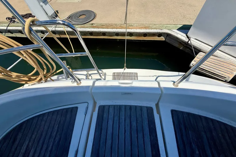 Slide: The Image of Beneteau Oceanis Clipper 311, 2002 model, docked with visible deck and railing. - 21