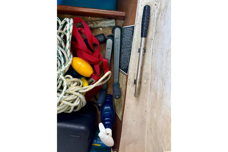 Slide: The Image of Storage compartment on a 2002 Beneteau Oceanis Clipper 311 with ropes and tools. - 22