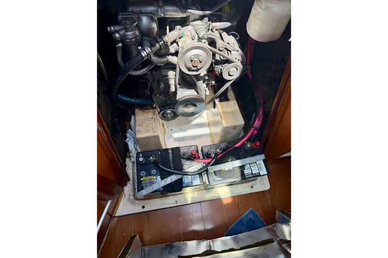Slide: The Image of Engine compartment of a 2002 Beneteau Oceanis Clipper 311 sailboat, featuring batteries and mechanical components. - 28