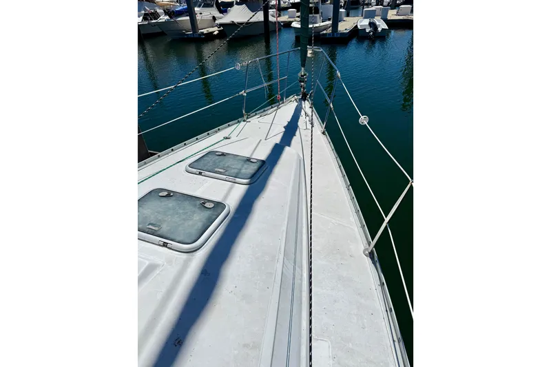 Slide: The Image of Deck view of a 2002 Beneteau Oceanis Clipper 311 sailboat in a marina. - 5