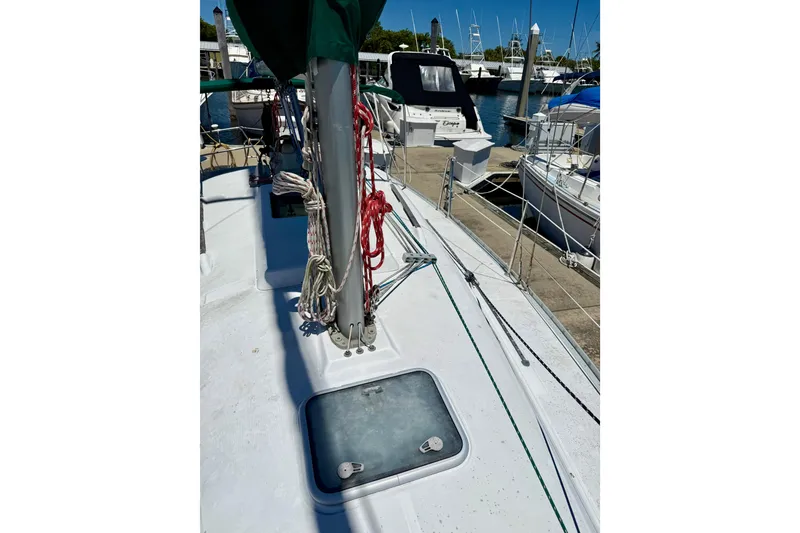 Slide: The Image of 2002 Beneteau Oceanis Clipper 311 sailboat deck with ropes and hatch in marina. - 6