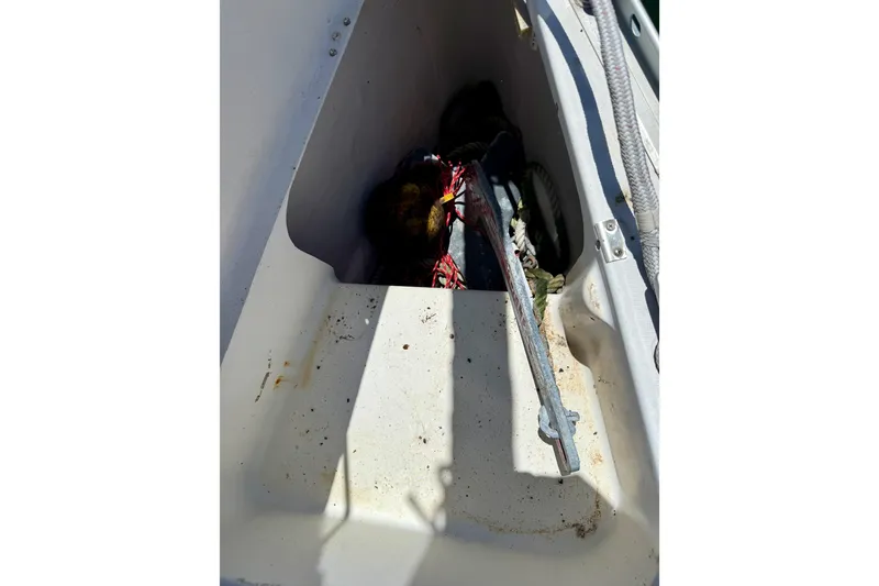 Slide: The Image of Storage compartment on a 2002 Beneteau Oceanis Clipper 311 sailboat, containing ropes and equipment. - 7