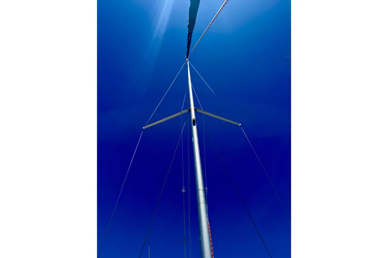 Slide: The Image of Mast of 2002 Beneteau Oceanis Clipper 311 sailboat against clear blue sky. - 9