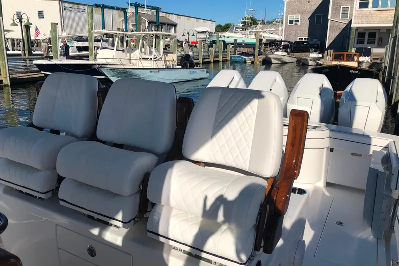 Slide: The Image of 2025 Valhalla Boatworks V-41 with luxurious white seating at a marina. - 12