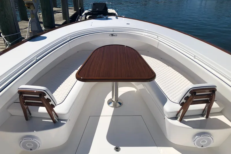 Slide: The Image of 2025 Valhalla Boatworks V-41 interior with elegant seating and wooden table. - 14